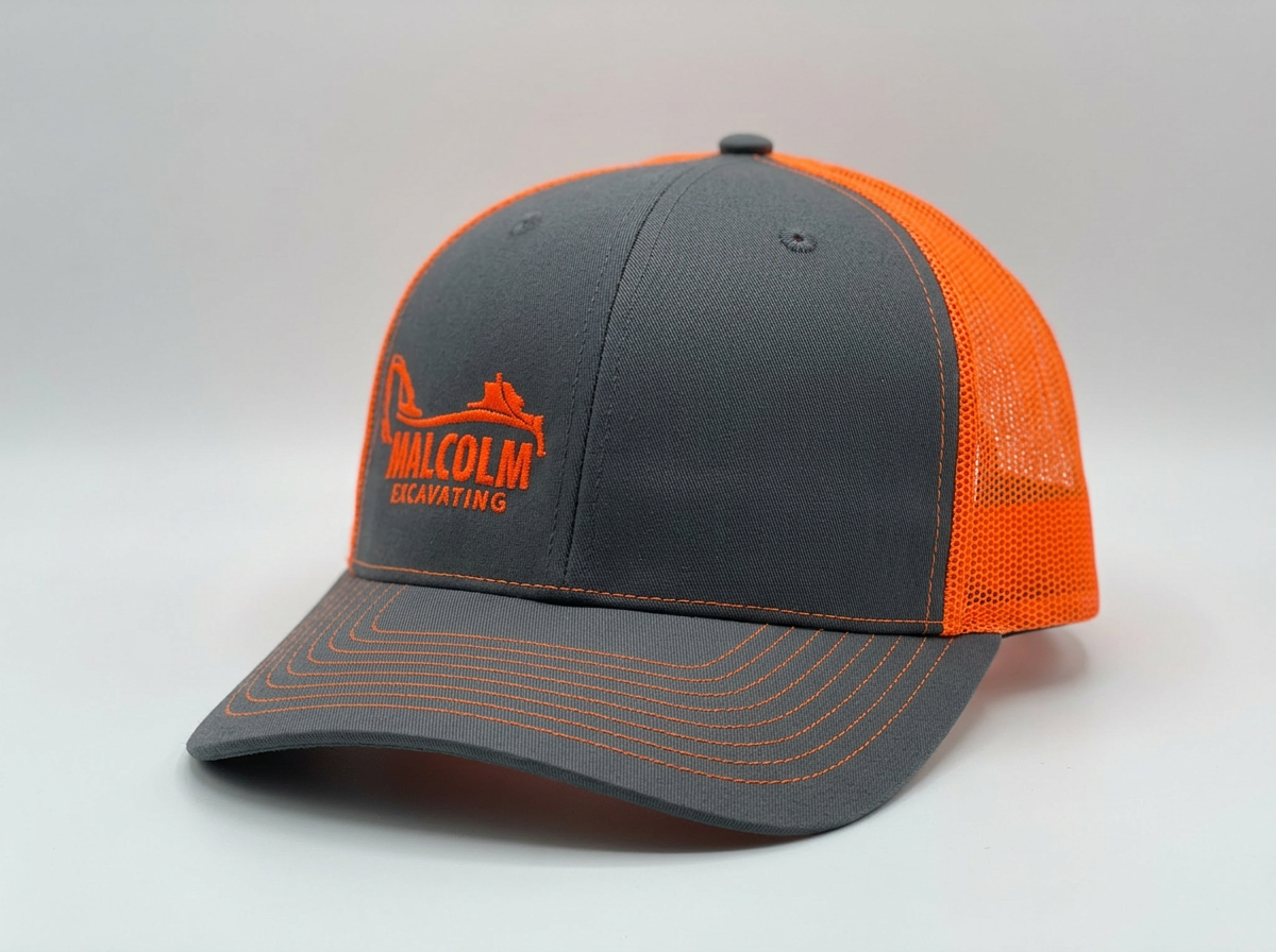 Charcoal and orange Malcolm Excavating trucker hat with embroidered front logo.